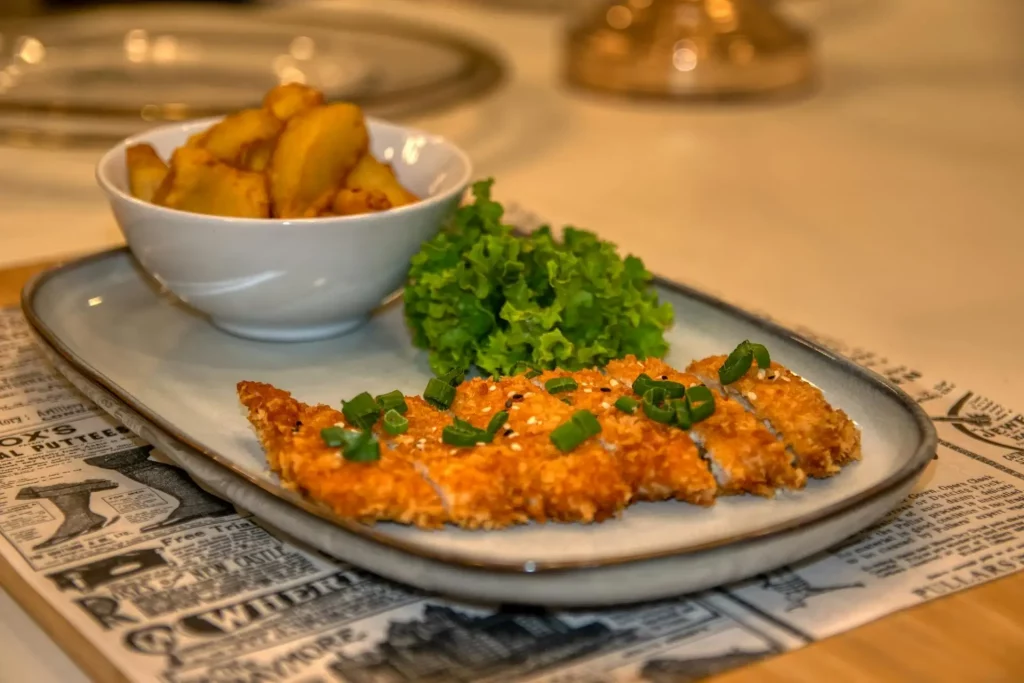 Kotlet na talerzu oraz ziemniaki i sałata
